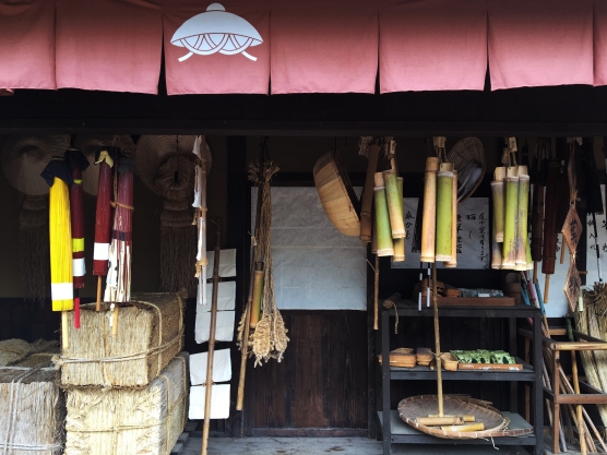 A shop displaying umbrellas and various straw and bamboo products.